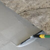 Close Up Photo Of A Crack In A Concrete Floor.
